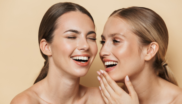 Two women smiling at eachother